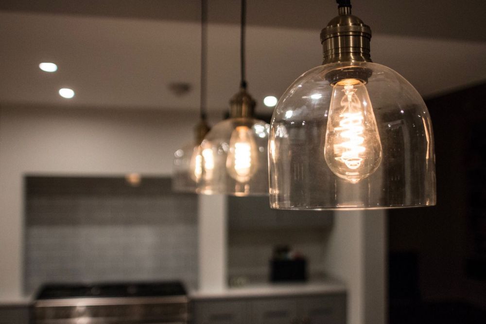 Glass Pendant LIghting with Squirrel Cage Bulbs over Inframe Island